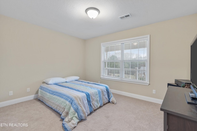 carpeted bedroom with a textured ceiling