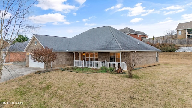 view of front facade featuring a porch, a garage, and a front yard