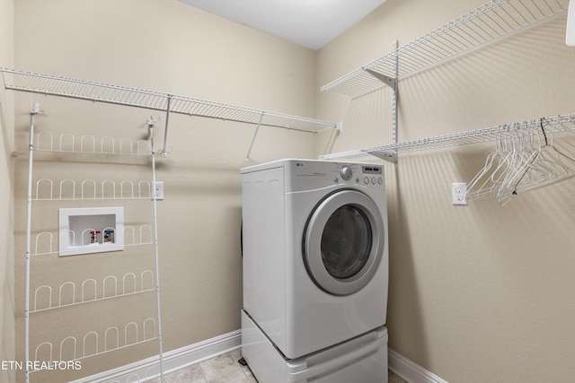 washroom with tile patterned flooring and washer / clothes dryer