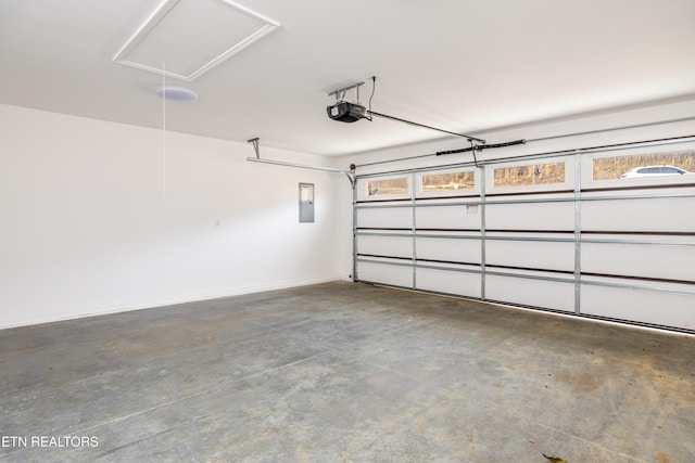 garage featuring electric panel and a garage door opener