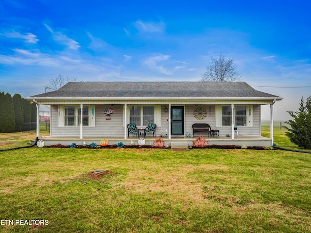 ranch-style house featuring a porch and a front yard