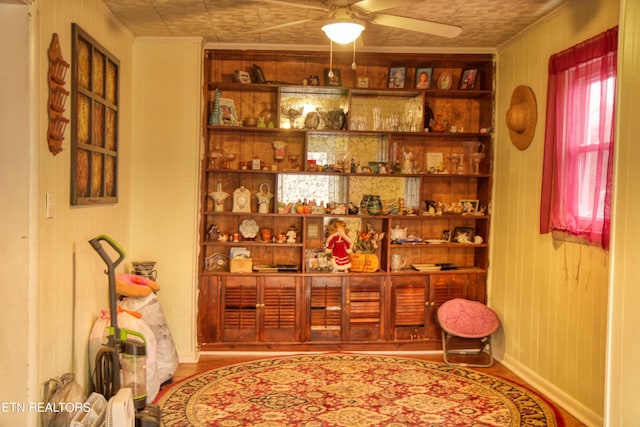 interior space featuring crown molding, ceiling fan, and hardwood / wood-style flooring