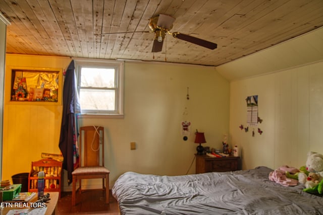 bedroom with lofted ceiling, wooden walls, hardwood / wood-style flooring, ceiling fan, and wood ceiling