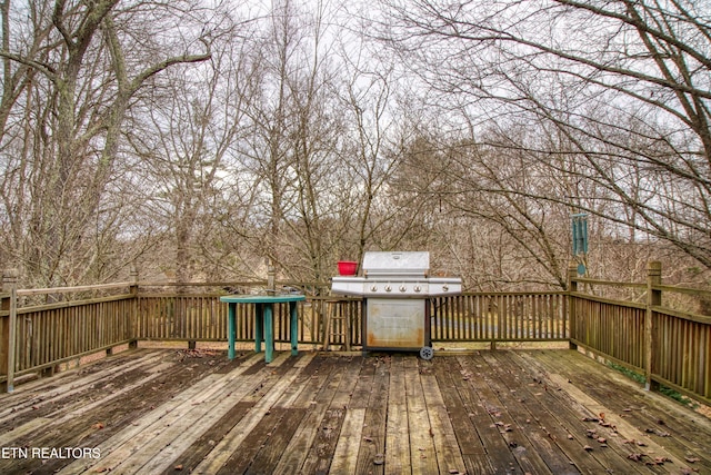 wooden terrace featuring area for grilling