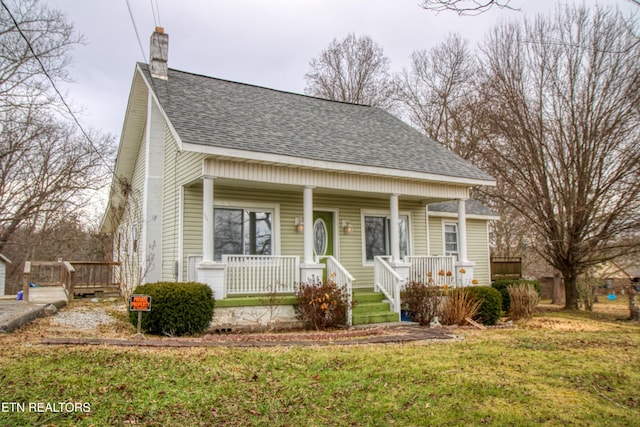 view of front of home with a front lawn and a porch