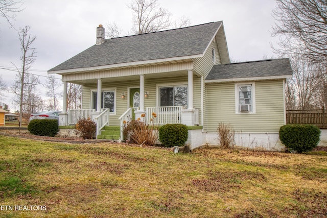 view of front of house with a porch and a front yard