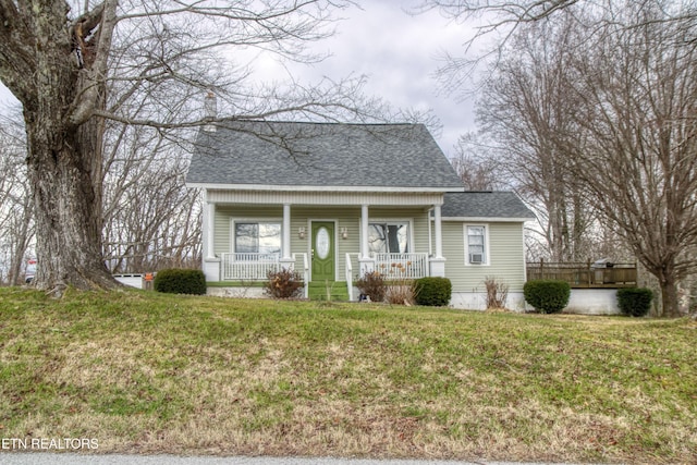 view of front of property with covered porch and a front yard