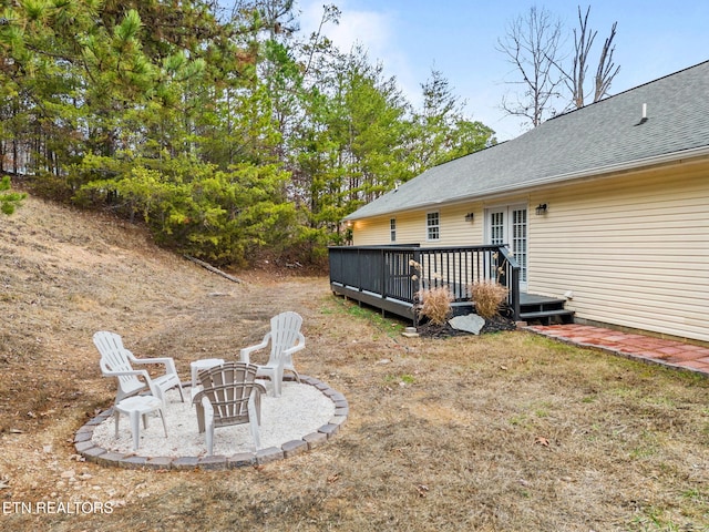 view of yard with a deck and a fire pit