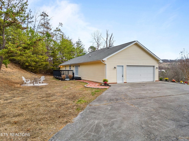 view of front of property featuring a garage and a deck