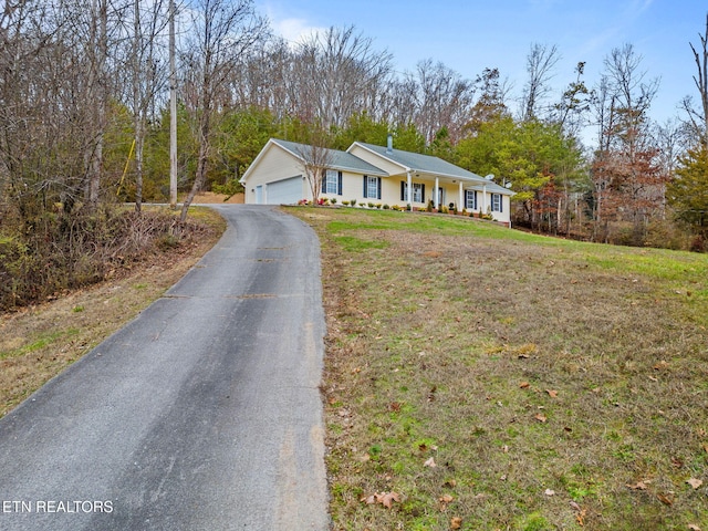 single story home with a front lawn and a garage