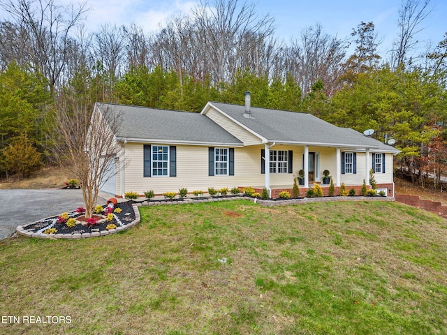 ranch-style home featuring a front yard