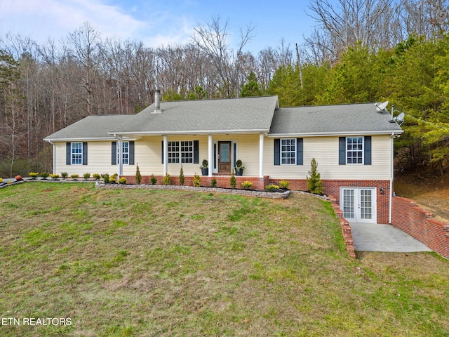 view of front of home with a front yard and french doors