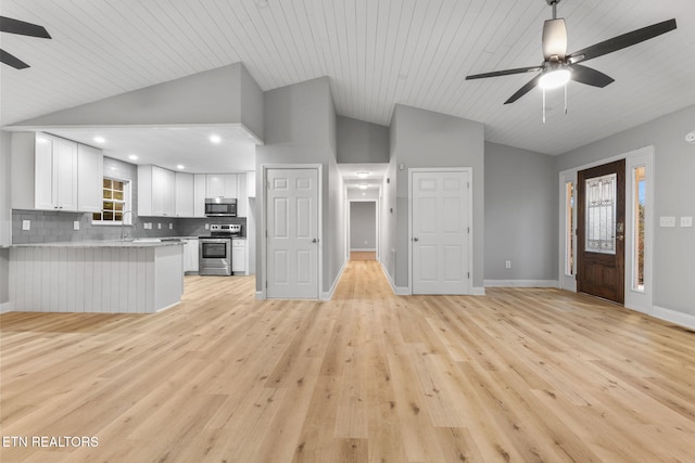 unfurnished living room with ceiling fan, light wood-type flooring, wooden ceiling, and vaulted ceiling