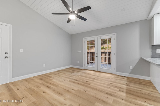 unfurnished room featuring french doors, wood ceiling, ceiling fan, light hardwood / wood-style floors, and lofted ceiling