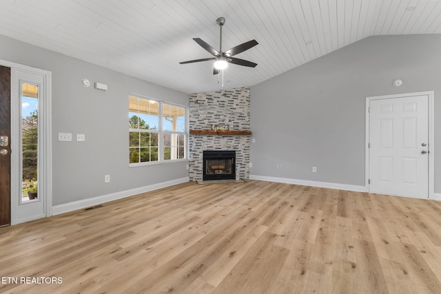 unfurnished living room featuring light hardwood / wood-style flooring, vaulted ceiling, ceiling fan, a fireplace, and wood ceiling