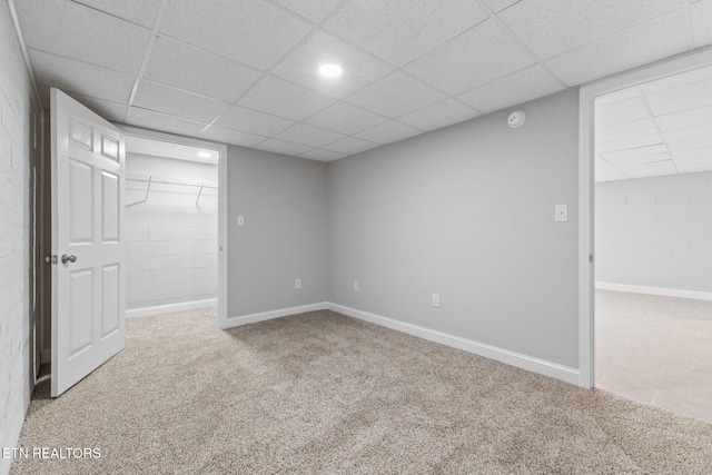 empty room with a drop ceiling and carpet floors