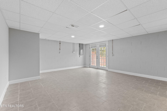 unfurnished room featuring a paneled ceiling and french doors