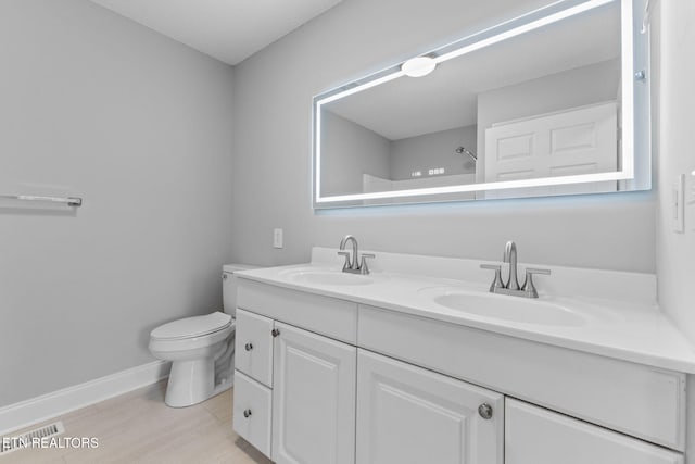 bathroom with a shower, vanity, and toilet