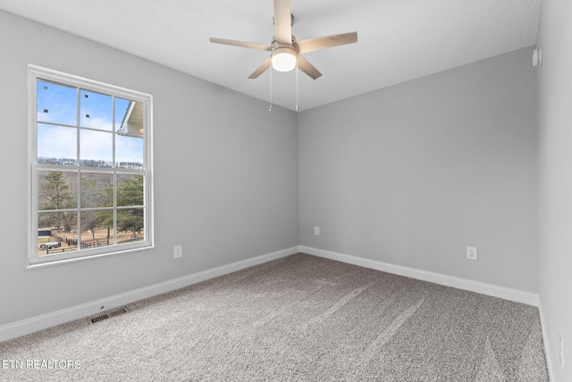 spare room with carpet flooring, ceiling fan, and plenty of natural light