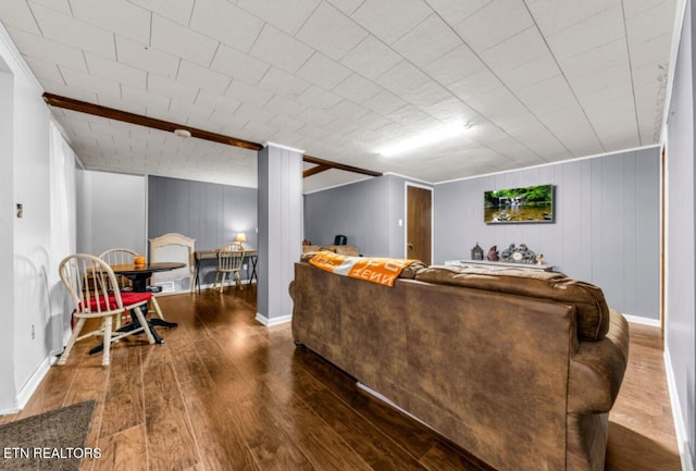 living room featuring hardwood / wood-style floors and wooden walls