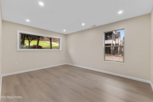 unfurnished room featuring light hardwood / wood-style floors