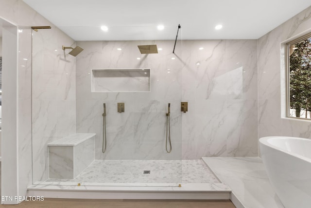 bathroom featuring separate shower and tub