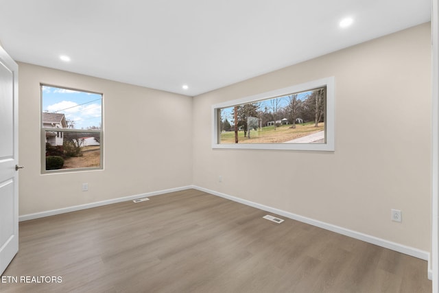 unfurnished room with light hardwood / wood-style flooring