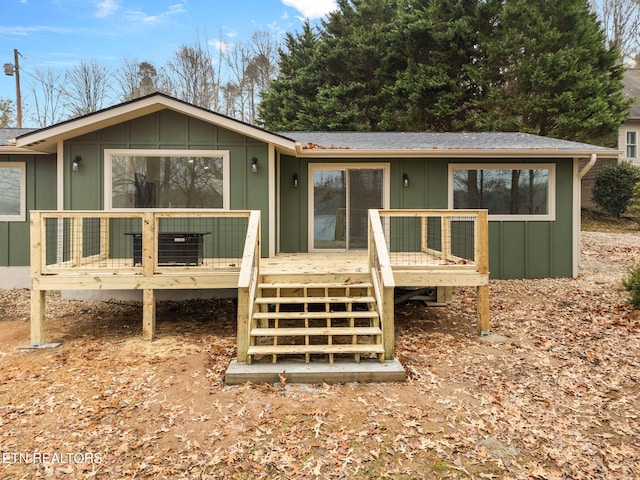 back of house featuring a wooden deck