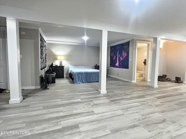 unfurnished bedroom with crown molding, ensuite bathroom, and light hardwood / wood-style floors