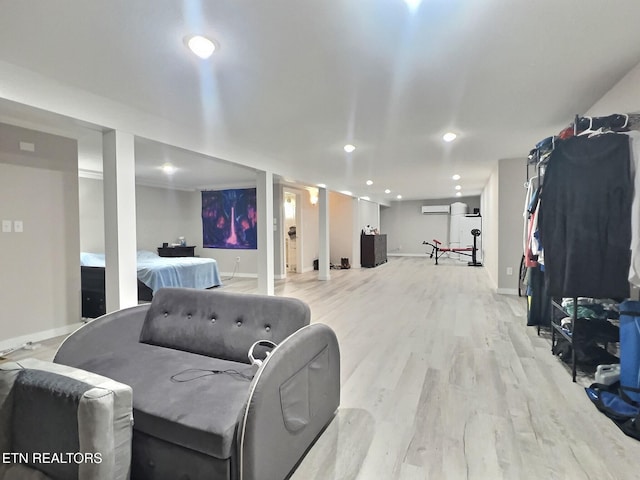 interior space featuring light wood-type flooring and a wall mounted AC