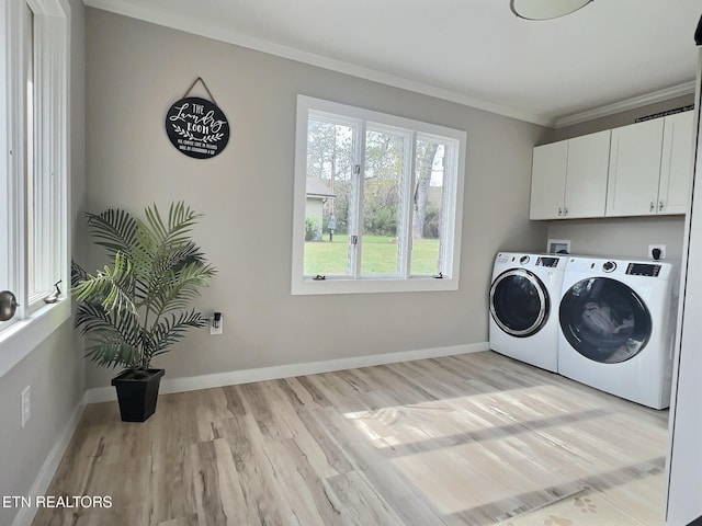 washroom with cabinets, light hardwood / wood-style flooring, washer and dryer, and ornamental molding