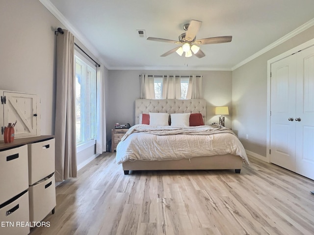 bedroom featuring multiple windows, light wood-type flooring, and ceiling fan