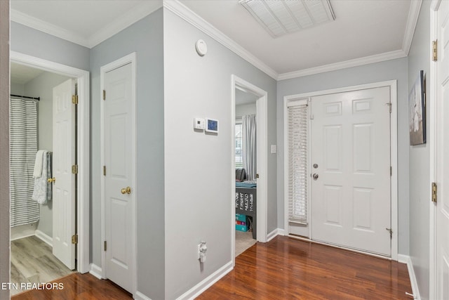 foyer entrance featuring crown molding and dark hardwood / wood-style floors