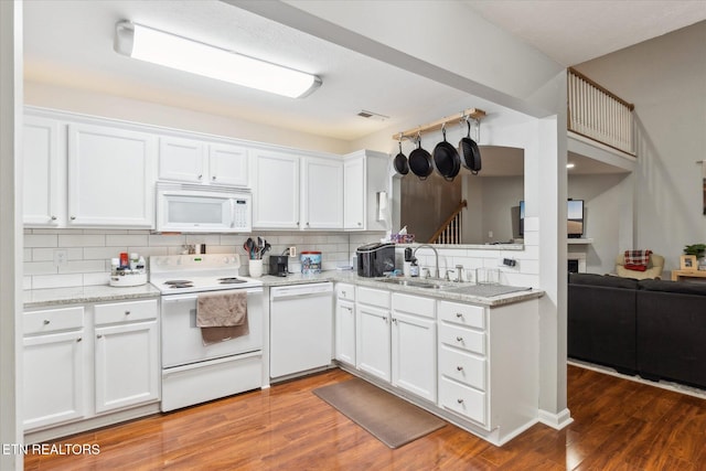 kitchen with white cabinets, white appliances, and sink