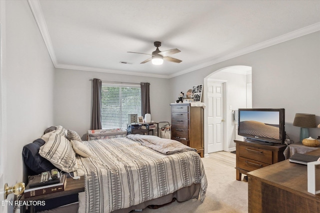 carpeted bedroom with ceiling fan and crown molding