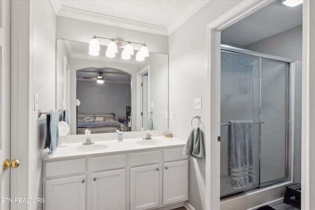 bathroom with ceiling fan, vanity, ornamental molding, and walk in shower