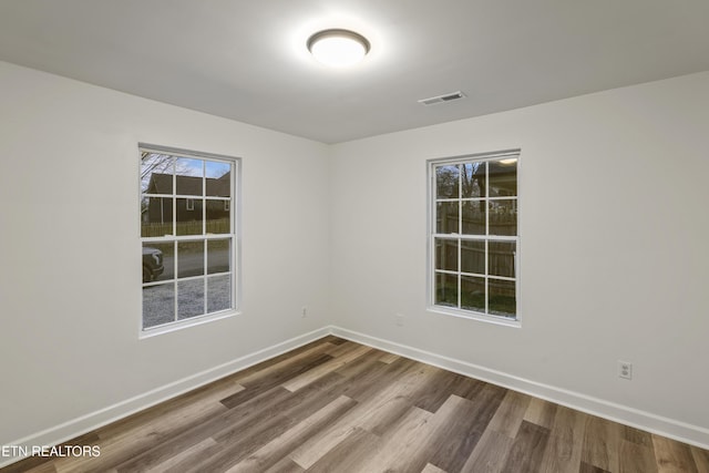 spare room with hardwood / wood-style flooring