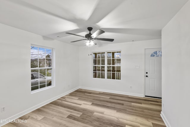 empty room featuring light hardwood / wood-style flooring and ceiling fan