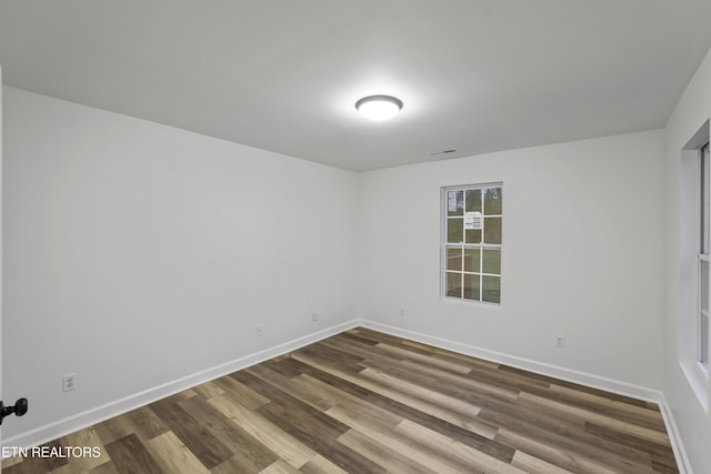 empty room with hardwood / wood-style flooring