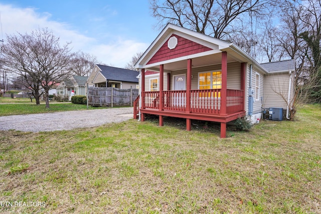 bungalow with a porch, a front yard, and central AC