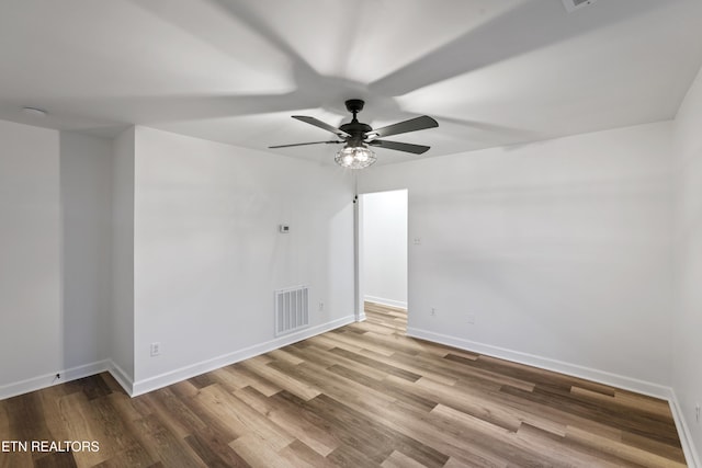 spare room featuring ceiling fan and hardwood / wood-style flooring