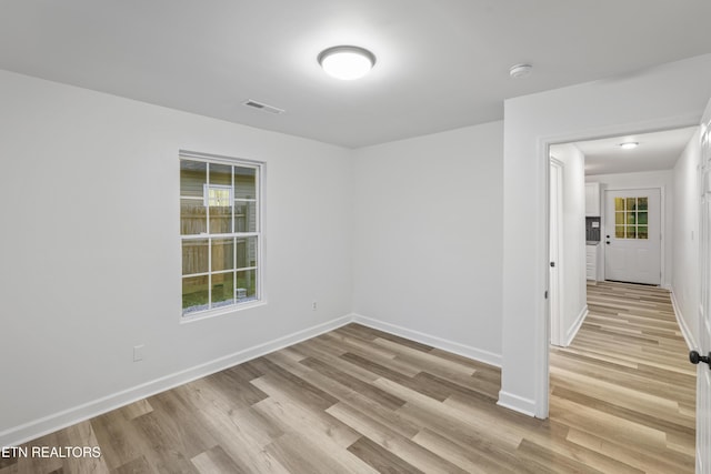 empty room with light hardwood / wood-style floors