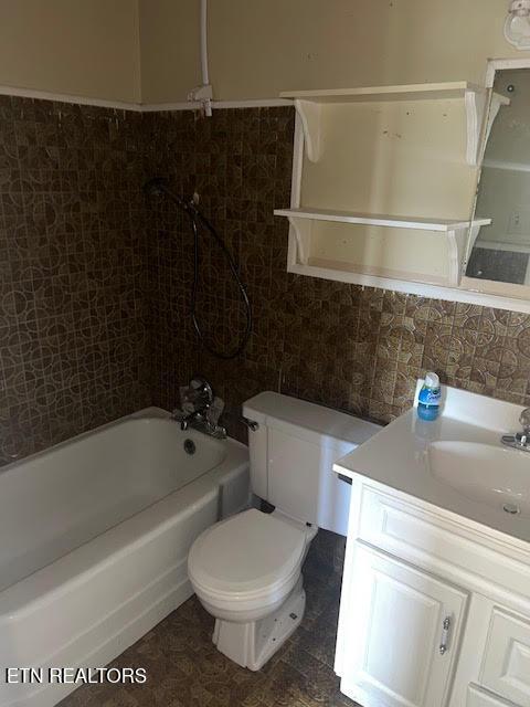 full bathroom featuring vanity,  shower combination, decorative backsplash, toilet, and tile walls