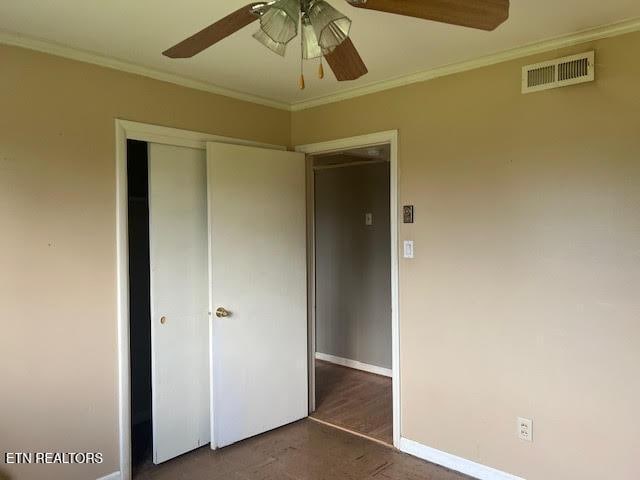 unfurnished bedroom featuring ceiling fan, ornamental molding, and a closet