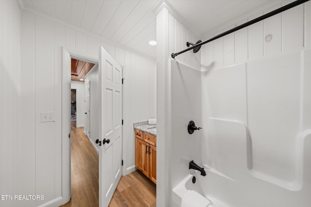 bathroom featuring hardwood / wood-style flooring, vanity, and shower / bath combination