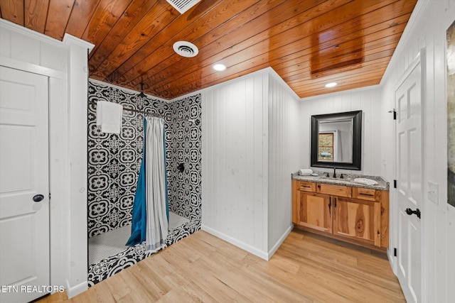 bathroom with walk in shower, wood-type flooring, wooden walls, vanity, and wood ceiling