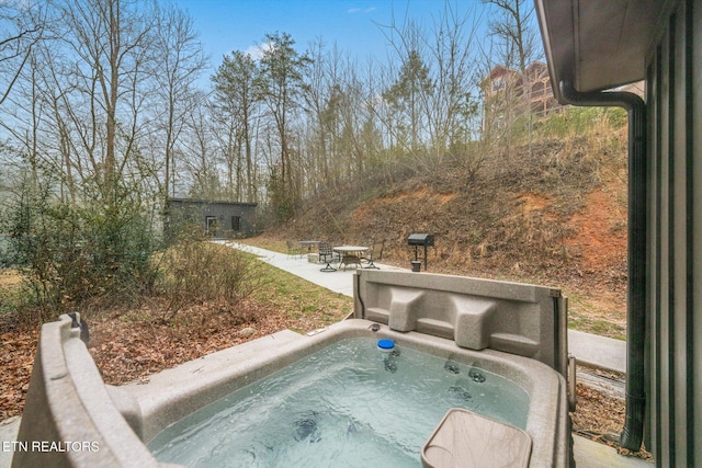 view of swimming pool with a covered hot tub and a patio