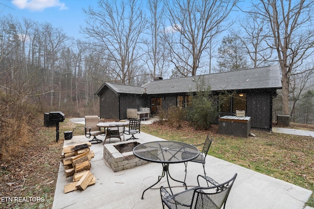 view of patio with cooling unit and a fire pit