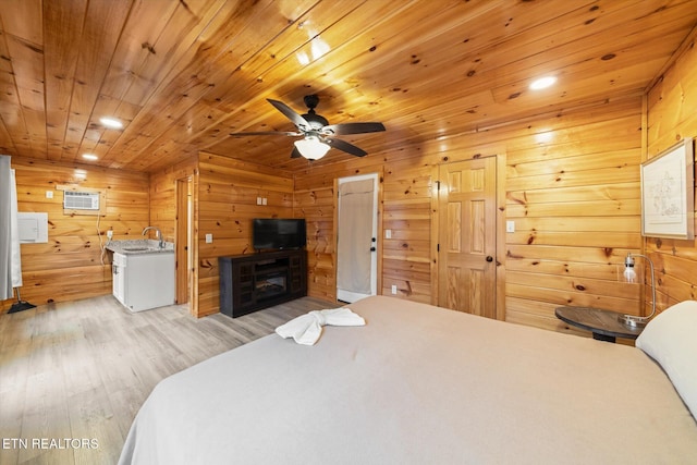 bedroom featuring a wall mounted air conditioner, sink, light hardwood / wood-style flooring, ceiling fan, and wood ceiling