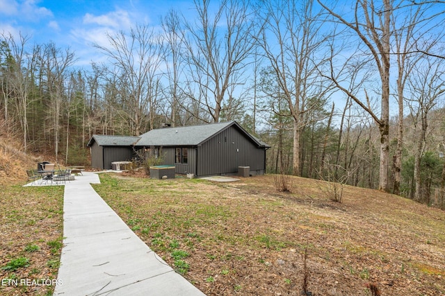 view of home's exterior with a yard and a patio